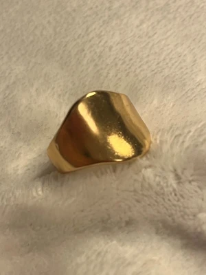 Chunky guldring✨ - Superfin guldring med slät, chunky design som ger ett modernt och elegant uttryck ✨ Perfekt statement-ring för dig som gillar minimalistiska smycken med edge.  ✨ Stilren & trendig ✨ Lätt att matcha med andra ringar ✨ Passar både vardag och fest  I fint skick 🤍 Skickas snabbt 📦 Skriv om du vill ha fler bilder!