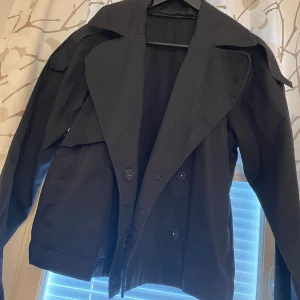Ginatricot new black short trench coat  - Ginatricot (new without tags) black short trench coat in size XS, also fits size S. https://www.vinted.fi/items/7191033854-ginatricot-black-short-trench-coat