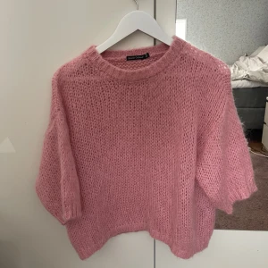 Rosa stickad tröja från Black Colour - Supermysig rosa stickad tröja från Black Colour i storlek S/M. Använd en gång, köpt för 699 kr. Varm och skön med kortare ärmar. 
