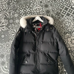 Moose Knuckles Q3 - Äkta moose knuckles jacka säljes. Kvitto finns!                   Jackan har två flaws. Den ena är att loggan har lite repo( bild2) och att ett band har lossnat(bild 3) därav priset