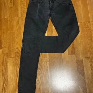 Gråa slim fit jeans från dondup - Snygga gråa jeans från dondup i slim fit-modell. Jeansen har klassisk femficksdesign, diskreta slitningar och raka ben. Tillverkade i bomull med en skön stretch. Perfekta för dig som gillar en smalare passform och stilren look.