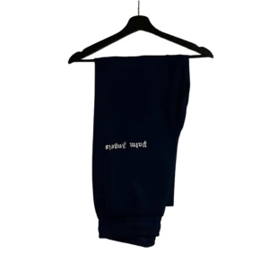 Palm Angels blåa  mjukisbyxor - Blåa mjukisbyxor från Palm Angels med vit logotyp på benet. Byxorna har snörning i midjan och ribbade muddar vid bensluten. Snygg och avslappnad passform, perfekt för en chill streetwear-look.