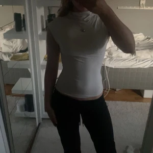 Vit tight polotopp i syntetmaterial - En jättefin topp från Gina som är i nyskick! 