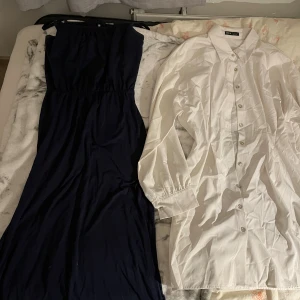 Marinblå långklänning och skjortklänning  - Säljer en stilren marinblå långklänning med resår i midjan och axelbandslös. Även en skjortklänning 