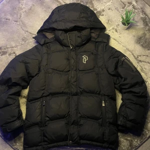 Peak Performance  - Peak Performance PufferJacka  Storlek: junior 150📏  Skick: 7/10♻️   Pris: 465kr💵   Färg: svart,grå och vit    Frakt: Fraktas samma dag, anländer till ditt hus inom 3-4 dagar🚚   Tveka inte att skriva vid minsta fråga!💭