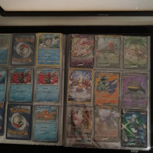 Pokemon pärm och pokemon kort  - Fet samlarpärm fylld med Pokémonkort! Här hittar du både klassiska och moderna kort, inklusive V, GX och specialkort. Perfekt för dig som vill boosta din samling eller börja byta med vänner. En grym mix för alla Pokémonfans och samlare! Perm medföljer!