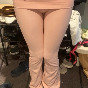 Ljusrosa mjukisbyxor med bootcut - Säljer ett par ljusrosa mjukisbyxor med bootcut-snitt. Byxorna har hög midja och är tillverkade i ett mjukt och stretchigt material som sitter skönt på kroppen. Perfekta för en chill och avslappnad stil.