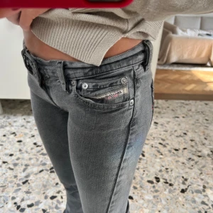Gråa Diesel jeans med bootcut - Säljer ett par gråa jeans från Diesel med låg midja och bootcut-ben!