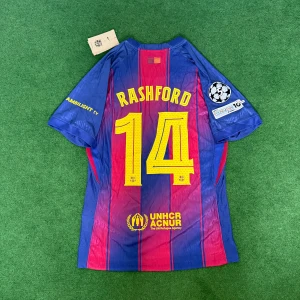 Barcelona 25/26  Rashford #14 Nike fotbollströja - Snygg Barcelona fotbollströja med Rashford och nummer 14 på ryggen. Tröjan är randig i blått och rött med gula detaljer, Champions League-märke på ärmen och Spotify-logga på bröstet. Tillverkad i lätt polyester, perfekt för match eller träning.