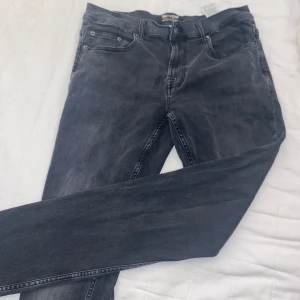 Svarta slim jeans Only & Sons W32 L34 - Snygga svarta jeans från Only & Sons i modellen Loom Slim. Jeansen har fem fickor, klassisk design och smal passform. Perfekta för dig som gillar en stilren look med lite tvättad finish. Materialet är mjukt och stretchigt för extra komfort.