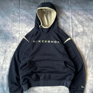 Y2K Nike Shox Hoodie – Rare 2000s - Authentic Nike Shox hoodie from the early 2000s Y2K era. Features bold embroidered NIKE SHOX logo across the chest, a lined drawstring hood with mesh interior, front kangaroo pocket, and iconic Swoosh logo on the sleeve.  Size: L (fits L/XL)  Condition: Great vintage condition, minimal signs of wear, no major flaws.  #NikeShox #Y2KStyle #NikeVintage #2000sStreetwear #VintageNike #Y2KHoodie #NikeSweatshirt #VintageStreetwear