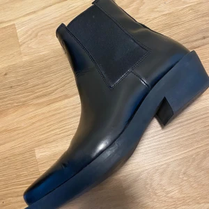 Svarta chelsea boots i skinn - Säljer ett par svarta chelsea boots i skinn. Snygga och stiliga, från & Other Stories. Kom gärna med bud och frågor!