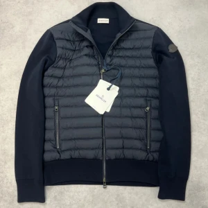 Moncler padded cardigan jacket - – Condition: Brand new with tags  – Retail price: 13 630 SEK  Please note that Moncler runs small, we recommend going up one size from your usual size.