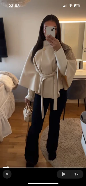 Beige kappa med bälte och knapp - Säljer denna för den ej kmr t användning, helt ny. Man får med knappar som är kvar på lappen. As snygg!!!