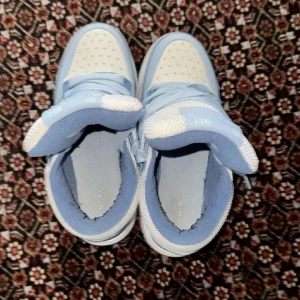 AMIRI MA-1 sneakers i ljusblått och vitt - Säljer ett par AMIRI MA-1 sneakers i en fräsch ljusblå och vit färgkombination. Skorna har mesh och skinnpaneler, tydlig AMIRI-logga på sidan och MA-1-detaljer på plösen. Klassisk snörning och chunky sula ger en modern vibe. Perfekta för dig som vill sticka ut.