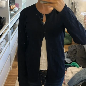 Mörkblå kofta från Saint Tropez - Snygg mörkblå supermjuk kofta från Saint Tropez med rund hals och hel knappstängning framtill. Långärmad och i mjuk bomull, perfekt att slänga över en topp. Enkel och stilren design som funkar till allt