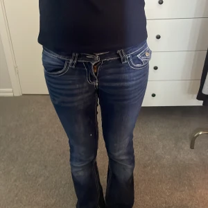 Mörkblå bootcut jeans med kontrastsömmar - Snygga mörkblå jeans med bootcut passform och markerade kontrastsömmar. Jeansen har klassiska fickor fram och bak. Stl 158 men skulle säga att de passar XXS/XS också. Priset kan diskuteras!