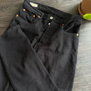Svarta Levi's Premium jeans straight fit - Svarta Levi's Premium jeans med klassisk femficksdesign och snygga kopparfärgade nitar. Jeansen har rak passform och är tillverkade i mjukt bomullstyg. Perfekta för dig som gillar en clean och tidlös look.