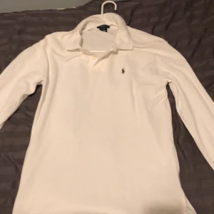 Vit långärmad pikétröja Polo Ralph Lauren - Hej, säljer en vit Ralph lauren långärmad piké, nypris är ungefär 1200kr men den är lite använd så jag säljer den för 650kr. Pris kan diskuteras vid snabb affär. Storleken är L för barn/ S för män.