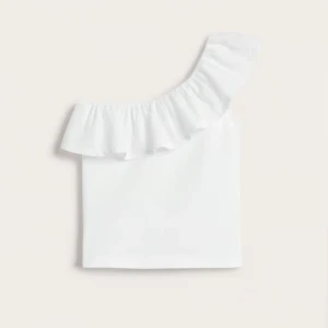 Vit oneshoulder topp med volang - Supersnygg vit topp med oneshoulder-design och bred volang längs halsringningen. Perfekt för dig som vill sticka ut med en stilren och trendig look. Gjord i mjuk bomull som känns skön mot huden. Passar Xs-S
