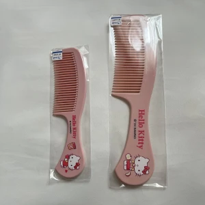 Hello Kitty rosa kammar i plast - Två söta rosa kammar med Hello Kitty-motiv från Sanrio. Kammarna är tillverkade i plast och har tryck med Hello Kitty som håller snacks och dryck. Perfekt storlek för väskan eller badrummet och supergullig design för dig som älskar kawaii-stil.