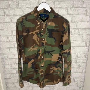Ralph Lauren skjorta - Snygg och välbevarad skjorta i camo-mönster från Ralph Lauren. Slim fit-modell, endast använd ett fåtal gånger och i mycket fint skick. Hör gärna av dig vid intresse! 🙌 