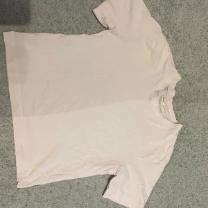 Ljusrosa t-shirt från Gina Tricot - Säljer en ljusrosa t-shirt från Gina Tricot, modellen Basically Basic. T-shirten har rund hals och korta ärmar, tillverkad i mjuk bomull. Väldigt bra skick!