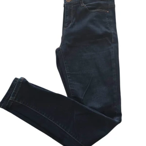 Mörkblå skinny jeans med dragkedja - Mörkblå skinny jeans från ESPRIT med klassisk femficksdesign och snygga kontrastsömmar. Jeansen har dragkedja vid benslut för en cool detalj. Stretchigt denimtyg som sitter tight och bekvämt. Perfekta till sneakers eller boots.