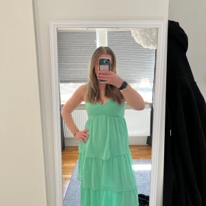 Pastell grön långklänning från Kappahl - Säljer en mintgrön långklänning från Kappahl med smock upptill och tunna axelband. Klänningen har flera volanger och är tillverkad i ett lätt, luftigt tyg🙌🏼 Storleken är mer S än xs och jag är 170! Funkar perfekt till bal eller andra sommarkvällar💕