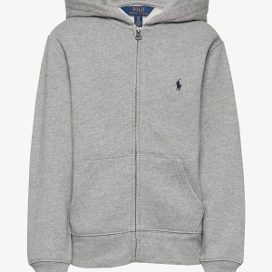 Grå hoodie från Polo Ralph Lauren - Klassisk grå hoodie från Polo Ralph Lauren med dragkedja framtill och huva. Broderad marinblå logga på bröstet. Perfekt för chill dagar eller när du vill ha en enkel och stilren look. Storlek L (14-16 år). Jätte fint skick, skriv för frågor eller fler bilder. Kostar 1195 ny💗