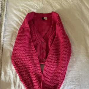 Rosa stickad kofta från Divided - Säljer en snygg rosa stickad kofta från Divided. Koftan har en v-ringning och knappar framtill. Perfekt för att lägga till en färgklick i din garderob! 💖
