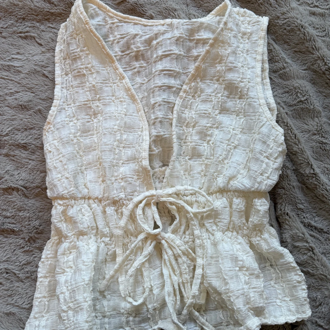 Vit topp med knyt i midjan