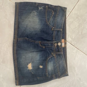 Vintage jeanskjol - Supersöt jeanskjol, vintage från bershka. Mörkblå med gula sömmar och coola slitdetaljer och är i fint skick❤️ storlek M möjligen S uppskattar jag, storlek 38 står på lappen