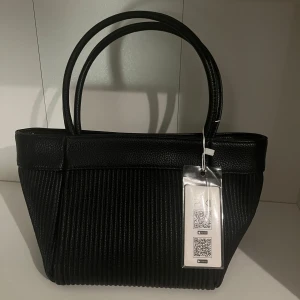 Svart axelväska från Pixi - Väskan har även en avtagbar axelrem med gulddetaljer som man kan välja att använda. Helt ny, aldrig använt. Pris går att diskuteras 💕