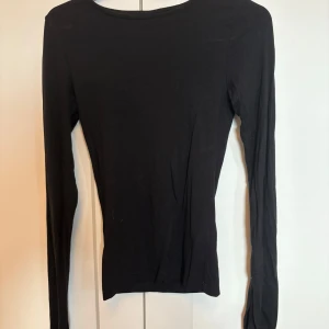 Svart långärmad tröja Gina Tricot - Svart långärmad tröja från Gina Tricot i storlek XXS. Enkel och stilren design med rund hals och smal passform. ”Slits” på ärmen, se bild. 