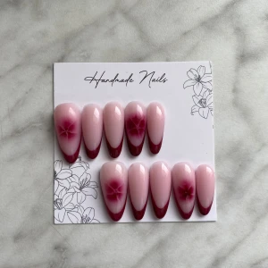 Somriga gelé naglar - Säljer ett set med handgjorda naglar i mandelform. Naglarna är ljusrosa med vinröd French. De är i storlek XS och allt som behövs för att sätta fast dem följer med.