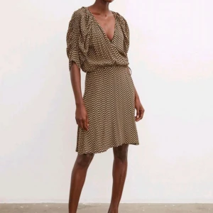 Mönstrad omlottklänning från By Malene Birger - Säljer en oanvänd omlottklänning från By Malene Birger i svart och beige mönster. Klänningen har v-ringning, knyt i midjan och kort ärm. Perfekt för dig som gillar en avslappnad men trendig stil. Nypris över 2000, blev tyvärr för liten för mig