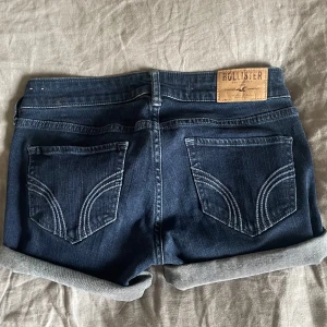Mörkblå jeansshorts från Hollister - Storleken är W24 och midjemåttet rakt över: 36cm.