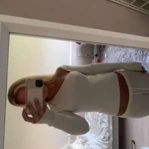 Vit ribbad långärmad croppad tröja - Säljer en superfräsch vit ribbad tröja med lång ärm och croppad passform. Tröjan har en tight siluett och är perfekt för dig som gillar en stilren och enkel look. Materialet är mjukt och stretchigt, vilket gör den riktigt skön att bära.