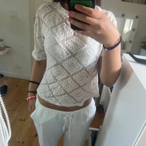 Vit virkad blus med kort ärm - Superfin vit blus med virkat mönster i rutor och korta ärmar. 