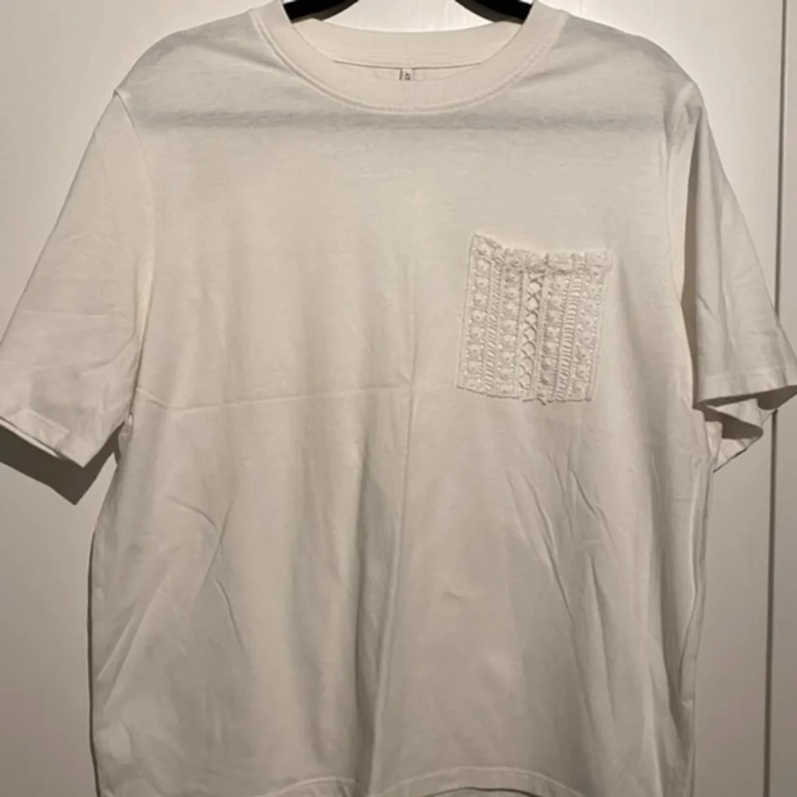 Vit t-shirt med spetsficka!