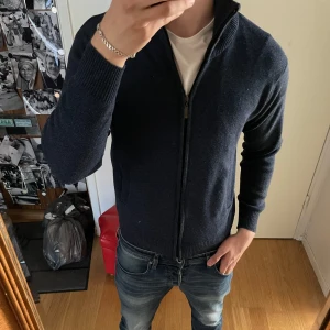 Mörkblå stickad kofta från Modaimpresion - Mörkblå stickad kofta. Sitter som small.