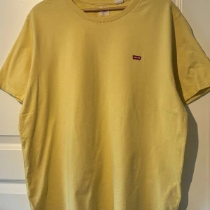 Gul t-shirt från Levi's - Säljer en enkel gul t-shirt från Levi's med liten röd logotyp på bröstet. Aldrig använd.
