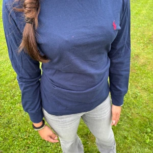Mörkblå tröja Polo Ralph Lauren - Snygg mörkblå långärmad tröja från Polo Ralph Lauren med röd broderad logga på bröstet. Den är i storlek 150, barnstorlek (passar xs-s vuxen) Använd 1-2 gånger och har ett mycket bra skick. Skriv om ni har fundering, pris kan diskuteras!💓