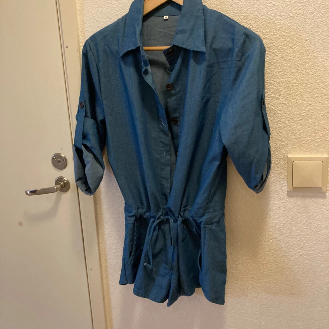 Blå kort byxdress med knappar och krage Stl M