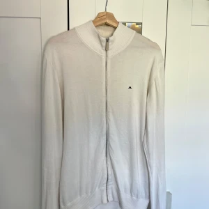 J.Lindberg full zip kofta  - En sällsynt och mycket fin tröja med full zip Storlek XL på lappen men sitter exakt som en L ska göra, därför väljer jag att lägga storlek L i annonsen Hel vit med en svart logga Skicka meddelande vid några funderingar Kolla gärna även in mina andra annonser