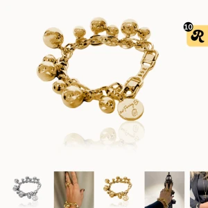 Guldfärgat armband med kulor från Ioaku - Säljer ett statement armband i guldfärg från Ioaku (original pris 699kr). Armbandet har stora, blanka kulor och en kedja med märkets logga på en bricka. Perfekt för dig som gillar att sticka ut med accessoarer. Jag har använt denna en gång och lådan ingår!