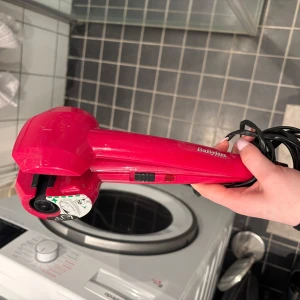 locktång  BaByliss - Säljer en röd locktång från BaByliss. Den har en automatisk lockfunktion och flera värmeinställningar. Perfekt för att skapa snygga lockar enkelt och snabbt. Användarvänlig design med tydliga instruktioner på sidan. Köpt för flera år sedan men använd endast några gånger. Funkar fortfarande och i bra skick. Pris kan diskuteras vid snabb affär. 