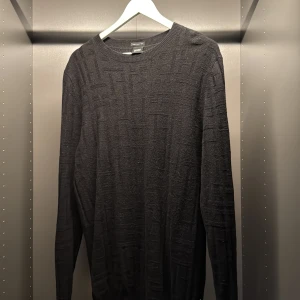 Cashmere Hugo Boss Orange tröja - Snygg svart tröja från Hugo Boss orange tillverkad av finaste italienska garnet. Tröjan har ett diskret mönster och långa ärmar, perfekt för en stilren look. Ribbstickad krage och ärmslut ger en klassisk touch. Nypris 2899kr