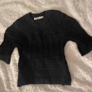 Mönstrad topp från NA-KD - Säljer en svart topp med mönster från NA-KD i storlek S men skulle säga att den är liten i storleken men stretchig!☺️